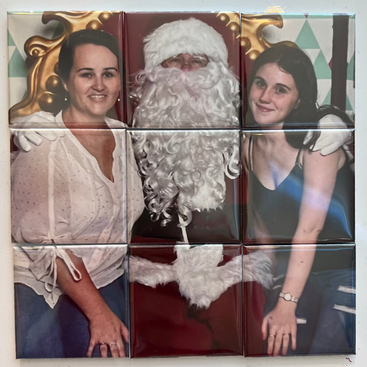 Mosaic wall art with a woman, Santa Claus, and another woman on a white background.